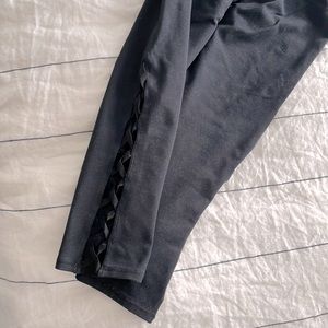 Fabletics cropped black legging. Cross detail on side slots.